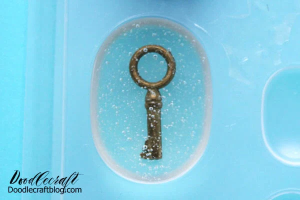 Repeat the process for mixing up more resin, about double to triple the amount as earlier. Then pour the mixed resin right on top of the key until the mold is filled. Use the torch or heat gun to pop any formed bubbles then set aside overnight to cure.