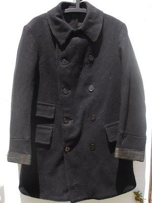 This is a British early 1950s pea coat style jacket.