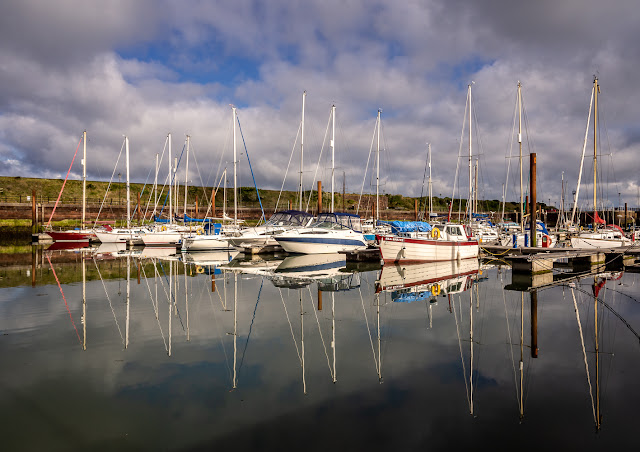 Photo of reflections in the calm water at Maryport Marina on Tuesday morning