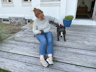 Marie sitting on front porch with Gismo the French Bull Terrier