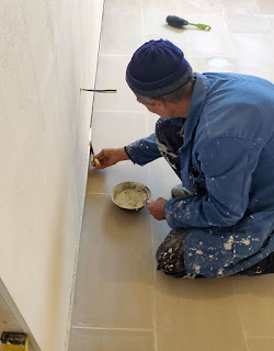 Sally applying grout on top of the edging tiles