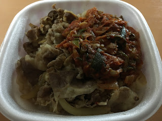 A picture of a large helping of beef and onion on a bed of rice known as "beef-bowl"