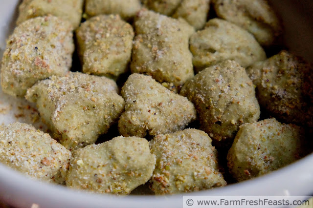 balls of matcha monkey bread dough rolled in pistachios, ready to rise in the fridge overnight