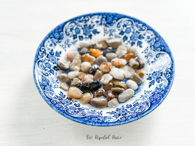 blue and white shallow bowl filled with stones