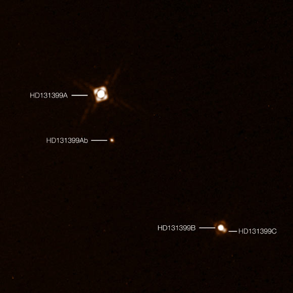 This annotated composite image shows the newly-discovered exoplanet HD 131399Ab in the triple-star system HD 131399. The image of the planet was obtained with VLT’s SPHERE imager. Image credit: K. Wagner et al / ESO.