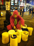 . treated to the image of a guy in a pink gorilla suit playing the bucket . (img )