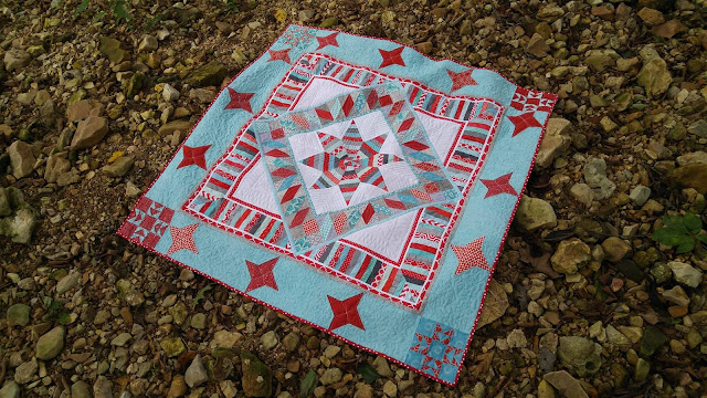 Red and aqua string star round robin quilt