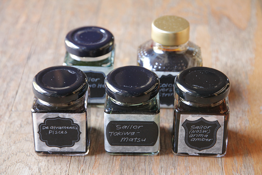 Four inks rebottled into Kaweco ink bottles. One ink rebottled in a Diamine bottle.