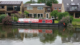 Houseboat with "Please Vote Remain" banner