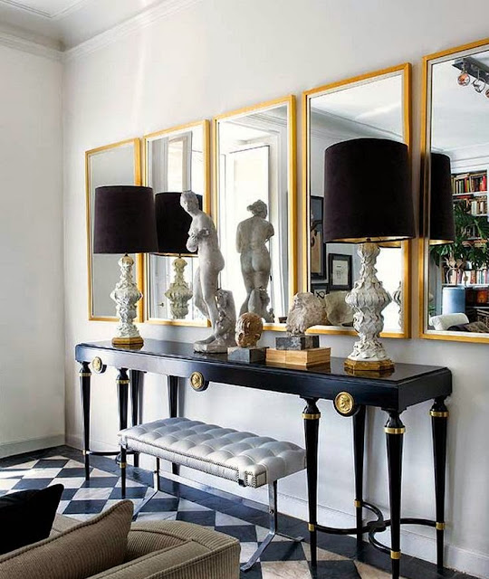 glamorous foyer decorating black console table gold mirrors black lamps tile floor