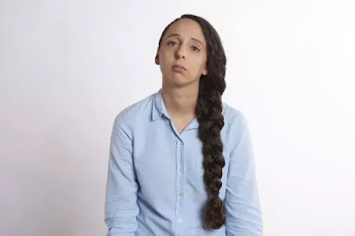 An image of a sad girl wearing a blue shirt and having a long pony tail- sad girl dp