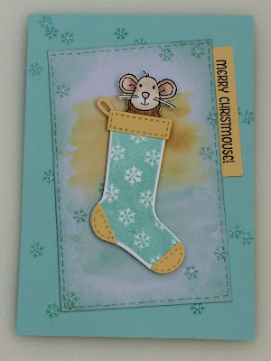 Mouse peeking out of a Christmas stocking