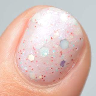 off white nail polish with pink shimmer and glitter