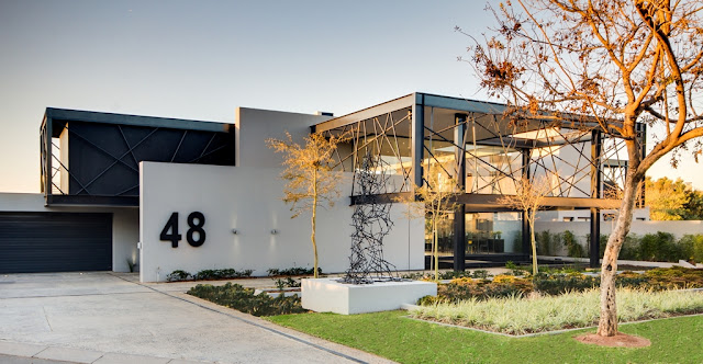 Picture of amazing modern mansion as seen from the street at sunset