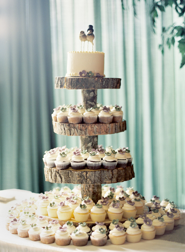 This rustic tiered tree cake and cupcake display is out of control