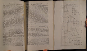 An open book of printed text with a fold-out diagram.