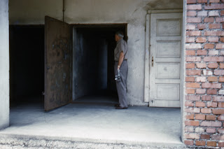 Charles looking into "ovens" at concentration camp in Dachau, Germany 