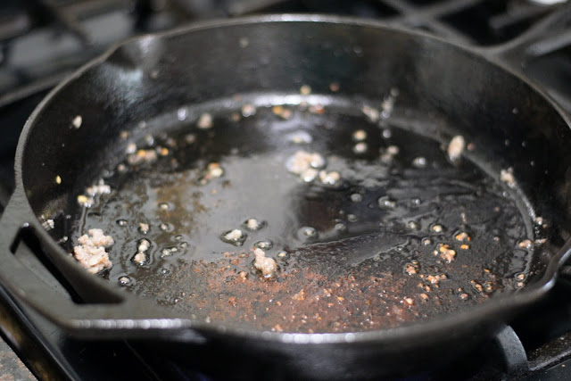 A empty cast iron skillet on the stove.