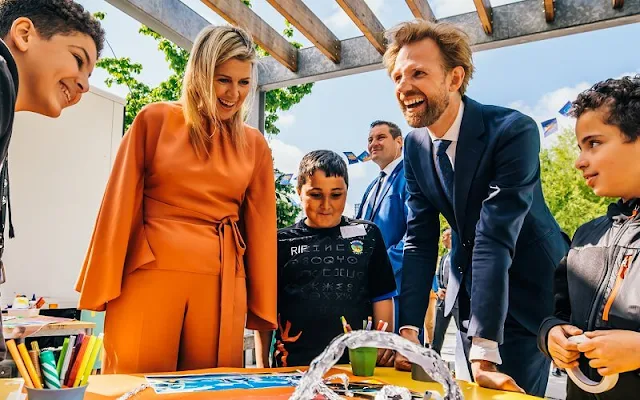 Queen Maxima wore a new coral outfit, silk blouse and wide-leg silk pants, by Natan