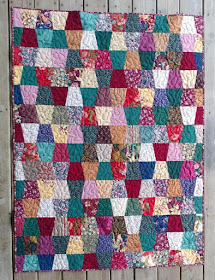 Tumbler quilt made with ugly fabrics