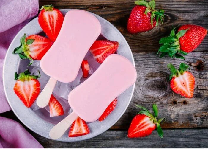 How to make strawberry yogurt popsicles with watermelon. These healthy frozen summer treats have yogurt for extra protein. These DIY desserts are sugar free and made with honey. Use flavored yogurt or fresh fruit for this easy recipe. Make homemade creamy pops for your kids or families. Clean eating can be yum yum! Add fresh fruit and berries in these 3 ingredient treats. #popsicle #healthy