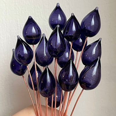 Handmade hollow lampwork glass headpins on copper wire by Laura Sparling