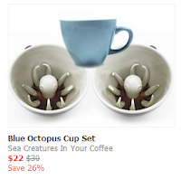 A coffee mug with a ceramic octopus on the bottom. 