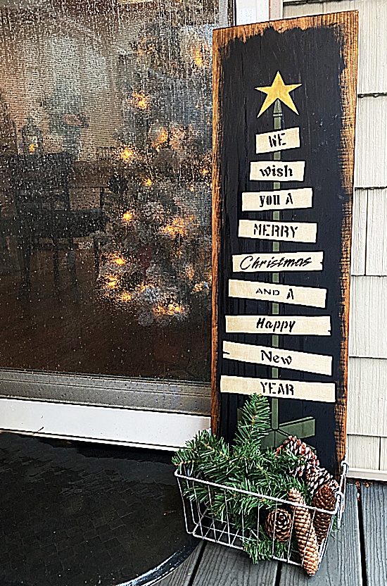 stenciled Christmas sign in the rain