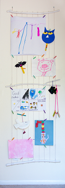 Colorful young child's artwork hanging on wall display