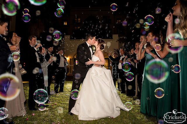 bride and groom kissing with bubbles