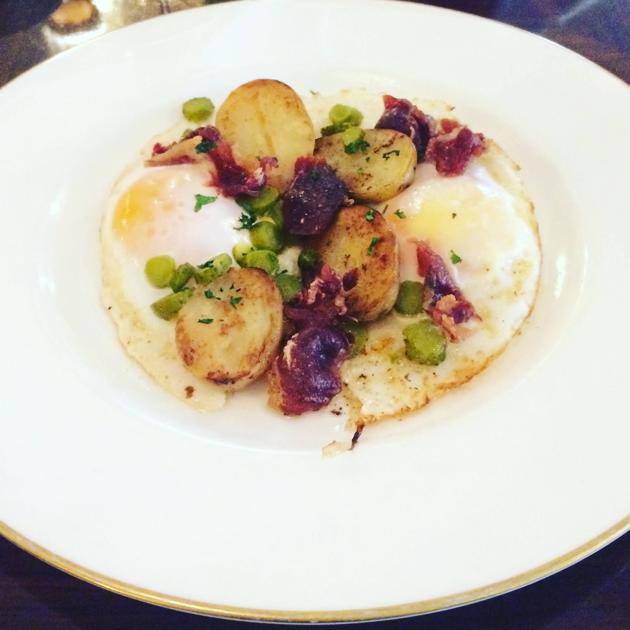 Plate of Fried potatoes, duck eggs and jamón at luxury London breakfast spot 45 Jermyn Street