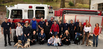 puppy club with firemen in front of firetruck