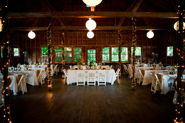 Burlap runners mason jars filled with loose floral arrangements and lantern