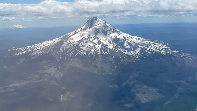 Another shot of Mount Hood as the plane flies around it. This shot shows the base of the mountain as well as the peak