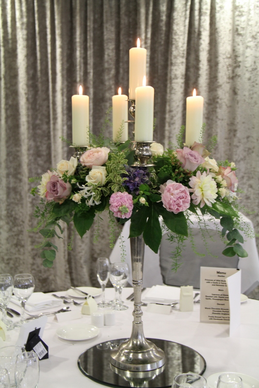 Tall Baroque style silver candelabras dressed with English Garden Roses 