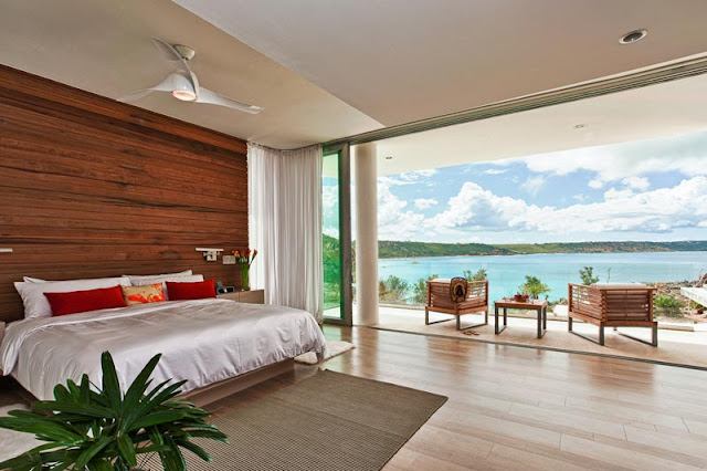 Another modern bedroom with wooden wall and a balcony