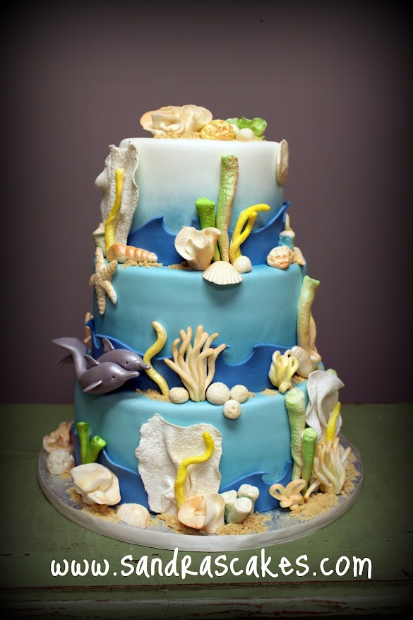 Beach Themed Cake Decorations / Nautical and Beach Wedding Cake Ideas - Wedding Themes - Use vibrant colors, like orange and yellow, to paint abstract strokes on a fondant cake.