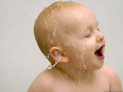 lovely baby kid playing with water while bathing 