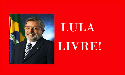 A imagem de fundo vermelho na parte direita está a foto do Presidente Lula e ao lado esquerdo com o lema LULA LIVRE!