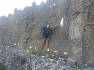 Wall with some holes, Murielle with backpack climbing a bit