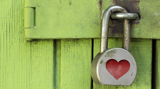 Decorative image of padlock with heart on wooden door