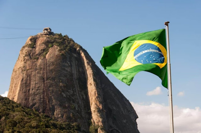 brazilian flag next to mountain