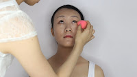 Modern Oriental Bridal Makeup - Use the tip of the beauty blender to apply her under eyes area