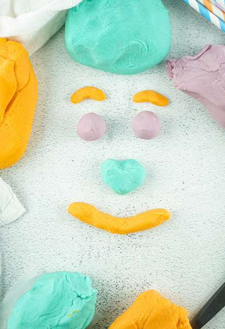 playdough shaped into a smiling face.