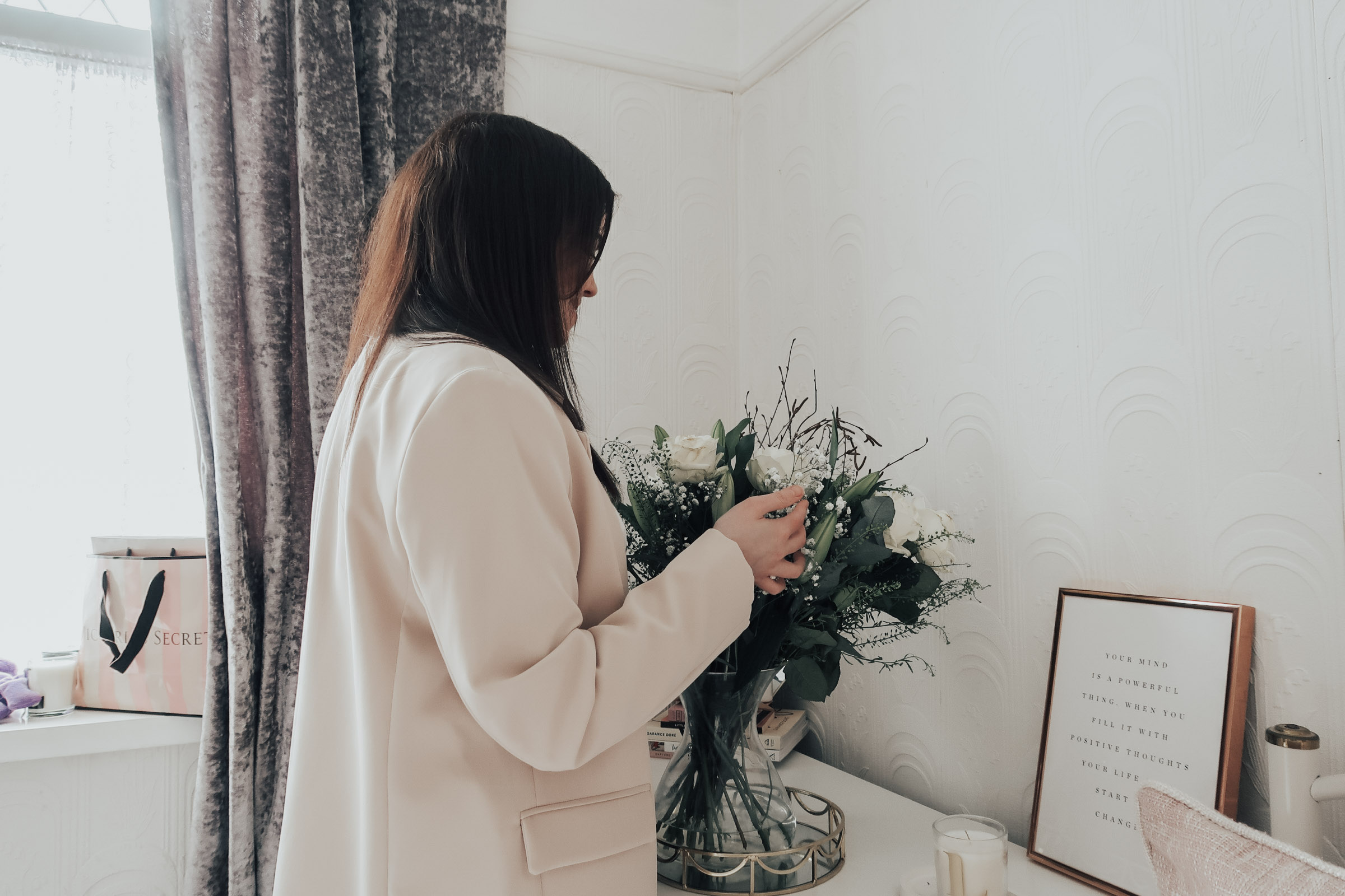 A woman looking at a bunch of flowers