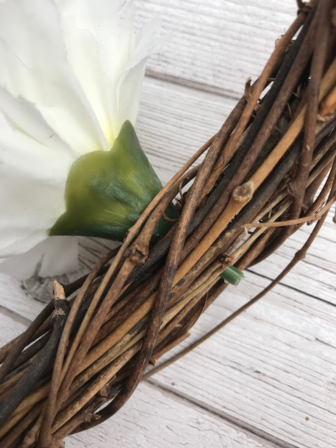 End of flower snipped so it is flush against the back of the wreath