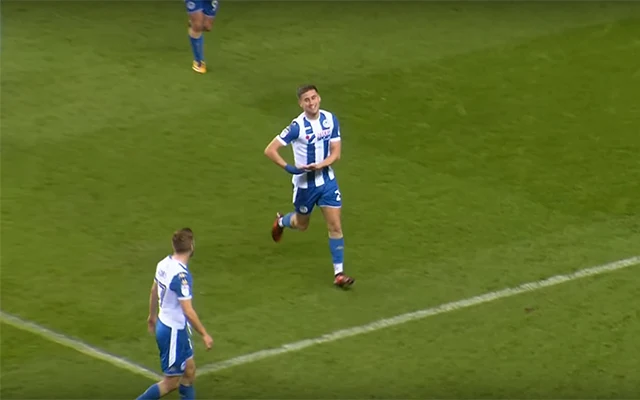 Wigan player Ryan Colclough celebrates after scoring against Doncaster by mimicking cradling a baby