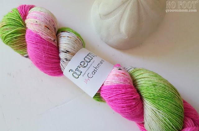 skein of preppy green, pink and white speckled and tonal yarn