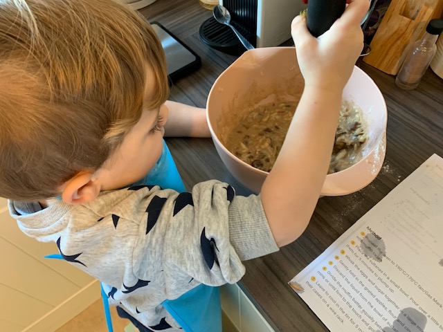 Boy mixing muffins ingredients in a bowl