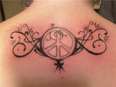 Peace sign with swirls on upper back tattoo